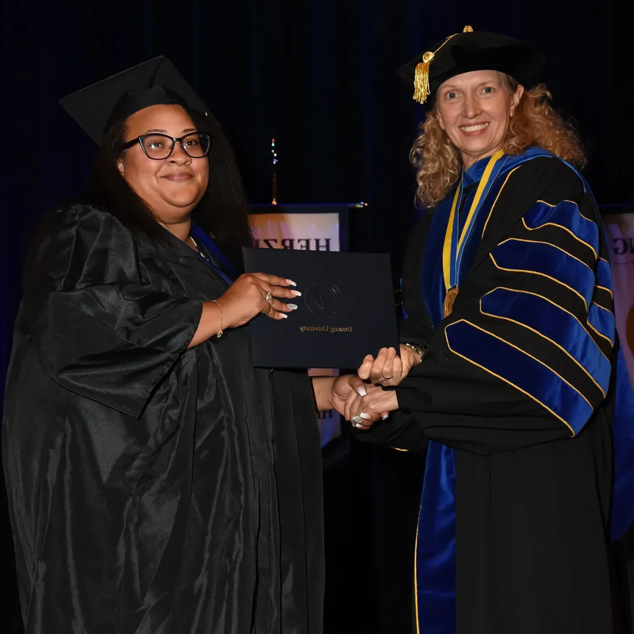 Herzing graduate receives diploma from Renee Herzing